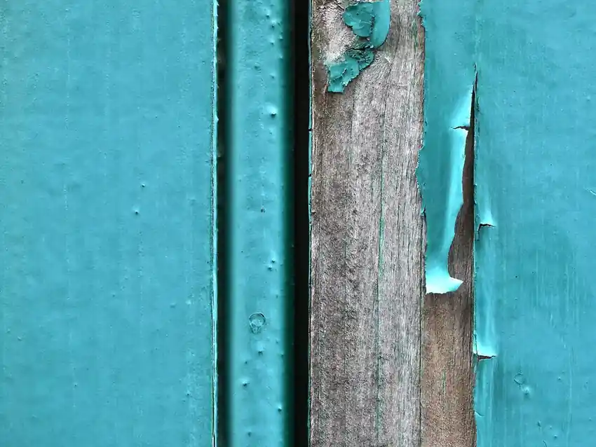 Old paint flaking away from weathered boards