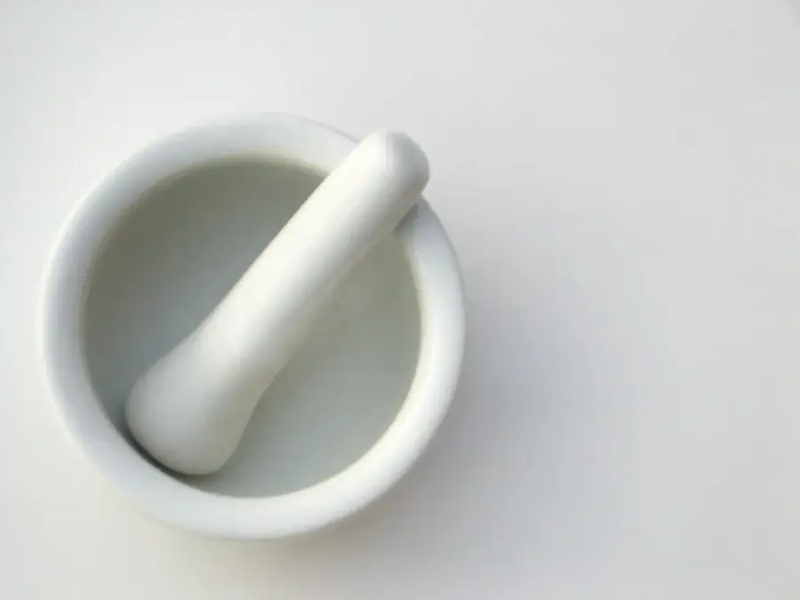 A white porcelain mortar and pestle